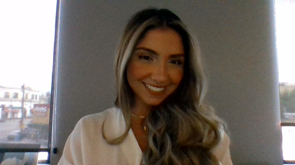 Woman with long hair smiling at camera.